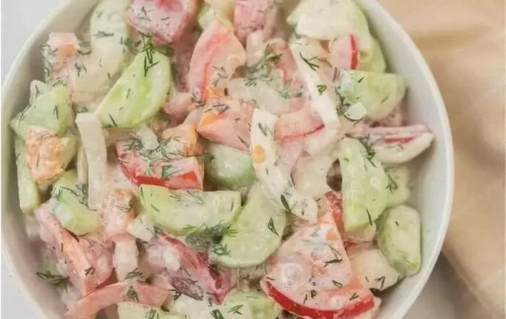 Fresh Cucumber Tomato Salad garnished with herbs in a bowl