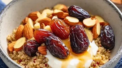 DASH diet quinoa breakfast bowl with yogurt, dates, and almonds.