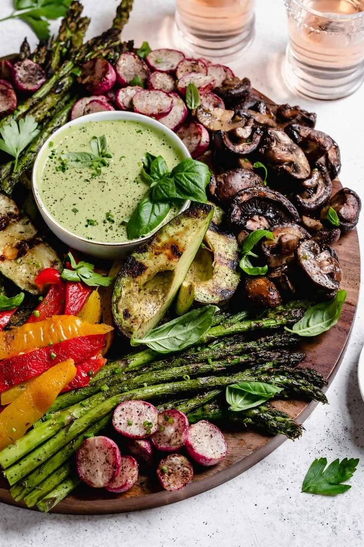 Colorful grilled vegetable platter with chimichurri sauce
