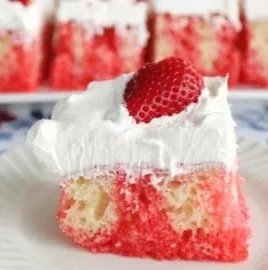 Easy Strawberry Poke Cake topped with fresh strawberries and whipped cream