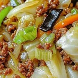 Chinese ground beef and cabbage stir fry in a colorful skillet