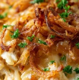 French Onion Chicken Orzo Casserole topped with melted cheese and onions