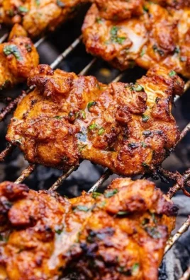 Grilled boneless chicken thighs on the grill, marinated and ready to serve.