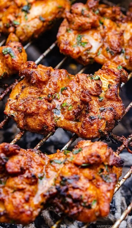 Grilled boneless chicken thighs on the grill, marinated and ready to serve.