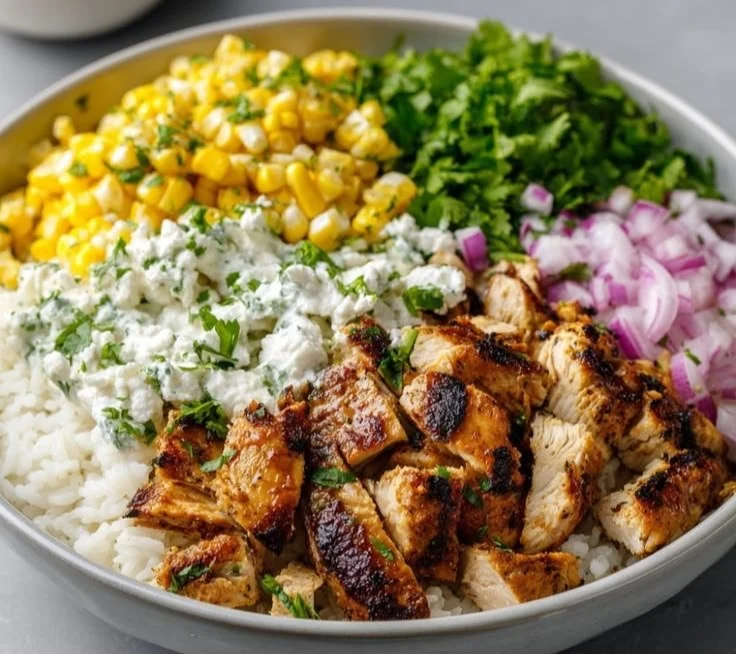 Grilled Chicken Bowl with cilantro lime rice and creamy Mexican street corn salad