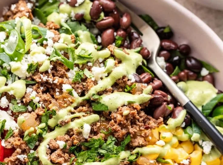 Ground beef taco salad bowl with fresh toppings and vibrant ingredients