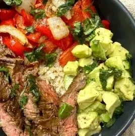 High protein steak fajita bowl with colorful vegetables and spices served in a bowl