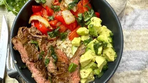 High protein steak fajita bowl with colorful vegetables and spices served in a bowl