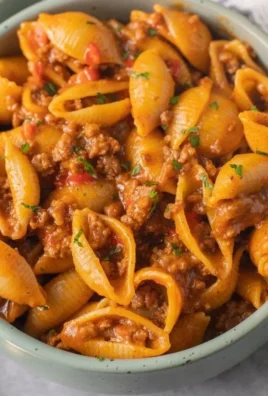 High protein taco pasta dish garnished with fresh toppings