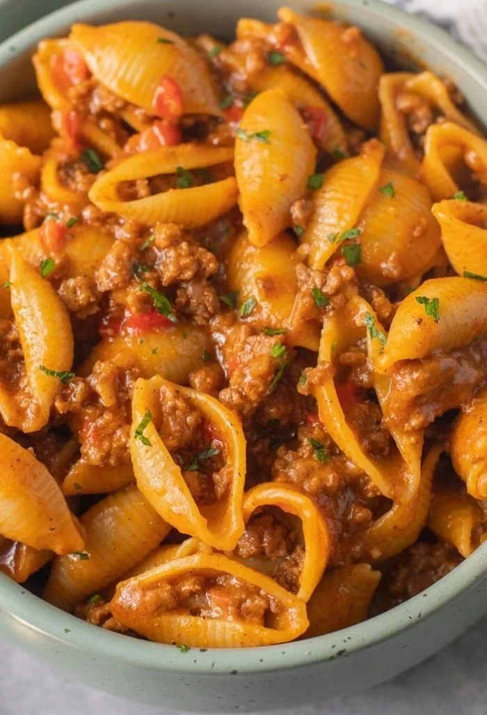 High protein taco pasta dish garnished with fresh toppings