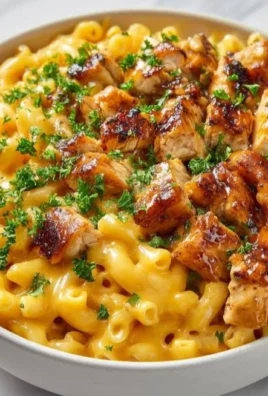 Honey Garlic Butter Chicken served with mac and cheese on a plate