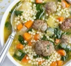 Delicious bowl of Italian Wedding Soup with meatballs and greens