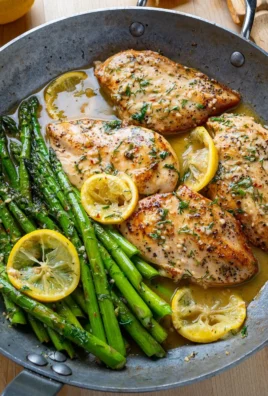 Lemon and dill butter garlic chicken with asparagus on a plate.