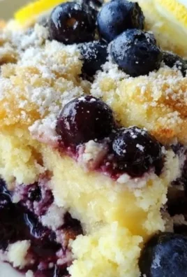 Lemon Blueberry Cheesecake Dump Cake served in a baking dish with fresh blueberries.