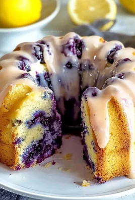 Lemon blueberry pound cake topped with fresh blueberries and lemon zest.