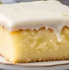 Delicious lemonade poke cake topped with lemon slices and whipped cream