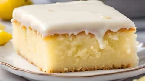 Delicious lemonade poke cake topped with lemon slices and whipped cream
