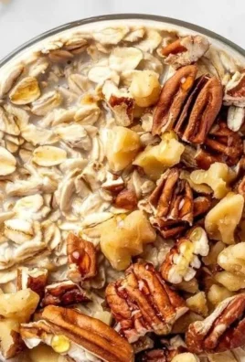 Maple brown sugar overnight oats in a bowl, topped with fresh fruit and nuts.