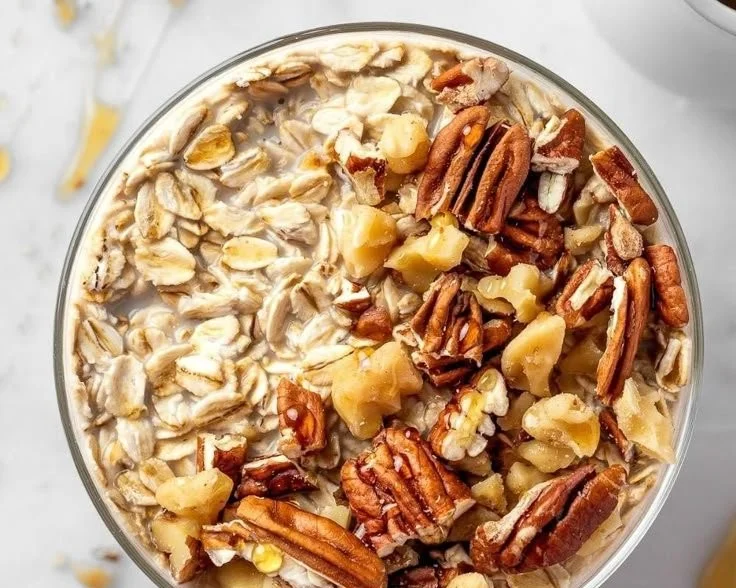 Maple brown sugar overnight oats in a bowl, topped with fresh fruit and nuts.