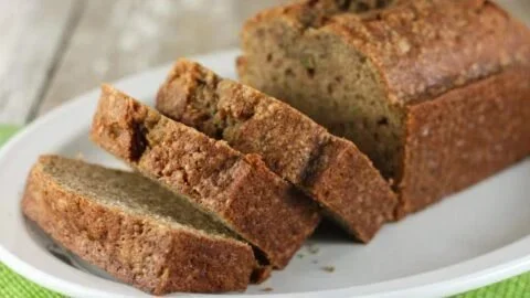 Delicious slice of Mom's Zucchini Bread on a wooden table
