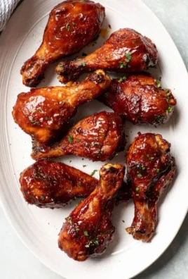 Oven baked chicken legs ready to serve with herbs and spices.