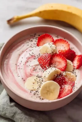 Delicious Protein Strawberry Banana Smoothie Bowl topped with fresh fruits and nuts