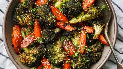 A serving of roasted broccoli and carrots, a healthy side dish.
