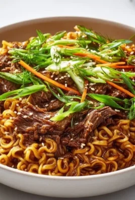 Slow Cooker Beef Ramen Noodles in a bowl with herbs and spices