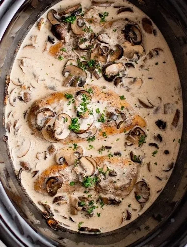 Delicious slow cooker mushroom chicken served with herbs and spices