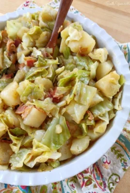 Delicious Southern-style cabbage and potatoes dish on a white plate.