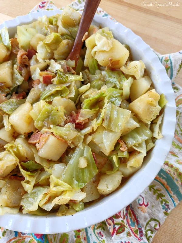 Delicious Southern-style cabbage and potatoes dish on a white plate.