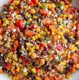 Colorful Southwest bean salad with beans, corn, and fresh vegetables.