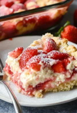 Delicious strawberry cheesecake dump cake with fresh strawberries and creamy topping