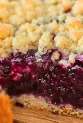Slice of Traditional German Blueberry Cake garnished with fresh blueberries