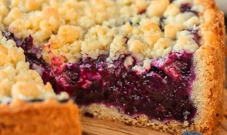 Slice of Traditional German Blueberry Cake garnished with fresh blueberries