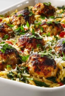 Delicious Tuscan Chicken meatballs with orzo served on a plate.