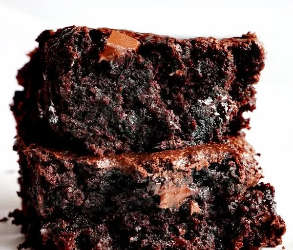 Deliciously moist zucchini brownies served on a plate, perfect for dessert lovers.